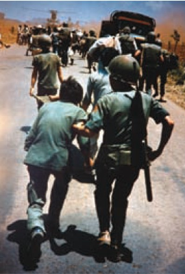 South Vietnamese soldiers help the wounded leave the embattled town of Xuan Loc.