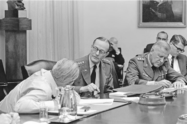 President Johnson &#40;leaning over&#41; meets with Generals Wheeler and Creighton Abrams, 26 Mar 1968.