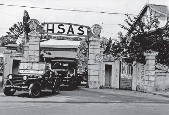 Army military police vehicles depart through the main gate of Headquarters Support Activity, Saigon.