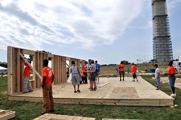 AmeriCorps members, veterans and civilian volunteers form seven houses at the Mall in Washington, D.