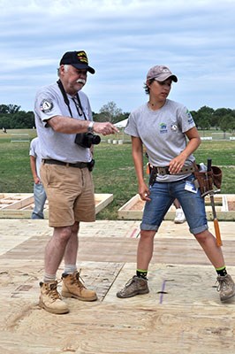 AmeriCorps members, veterans and civilian volunteers form seven houses at the Mall in Washington, D.