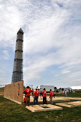 AmeriCorps members, veterans and civilian volunteers form seven houses at the Mall in Washington, D.