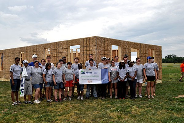 AmeriCorps members, veterans and civilian volunteers form seven houses at the Mall in Washington, D.