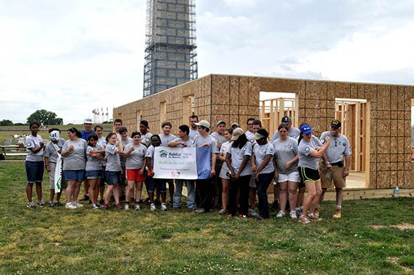 AmeriCorps members, veterans and civilian volunteers form seven houses at the Mall in Washington, D.