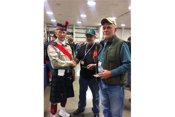Sgt. William Cole of the Northwest Scots Honor Guard presents Eagle Pins.