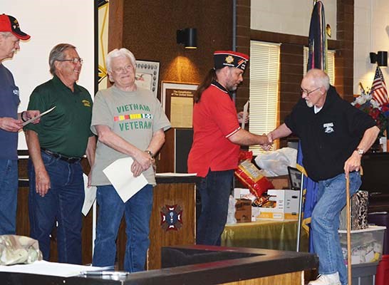 Vietnam veterans assemble on stage.