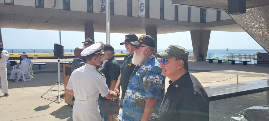 Photo of Milwaukee Mayor Cavalier Johnson and Rear Adm. Douglas G. Perry presenting VVLPs. 