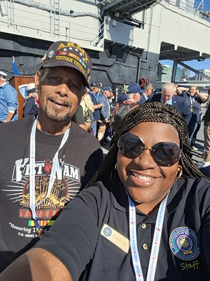 On 11/9/23, VWC's Social Media Manager Charlita Wiley takes a photo with a Vietnam veteran aboard th