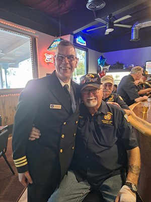 VWC Chief, Public Engagement, Cmdr. Brian Wierzbicki, USN, takes a photo with a Vietnam veteran