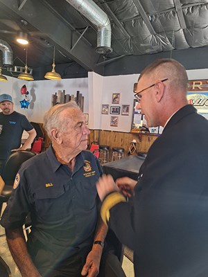VWC Chief, Public Engagement, Cmdr. Brian Wierzbicki, USN, pins a Vietnam veteran. 