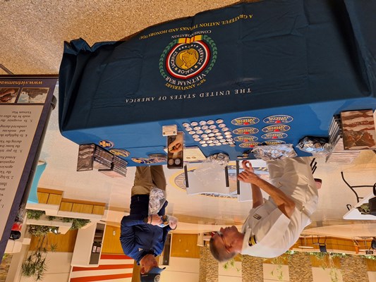 VWC's CDR Brian Wierzbicki and Luc Chiarenza distribute VWC items on the display table.