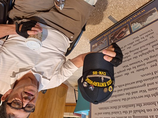 A Vietnam veteran proudly displays the VVLP on his hat that he just received.