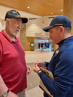 VWC's Luc Chiarenza prepares to pin a Vietnam veteran.