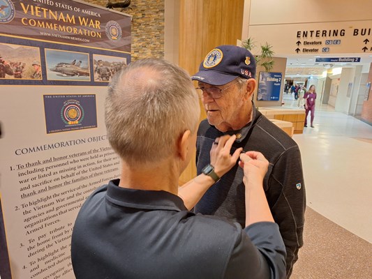 A Vietnam veterans gets pinned by VWC's Henry Polczer.