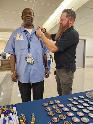A Vietnam veteran receives a VVLP from a VWC staff member.