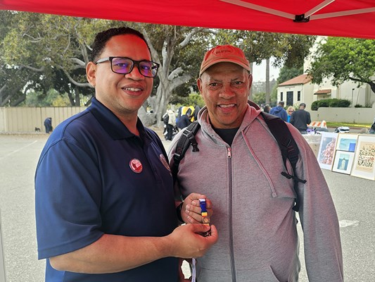A Vietnam veteran receives a VVLP from a VWC staff member.