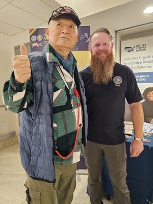 A Vietnam veteran poses with a VWC staff member after receiving a VVLP.