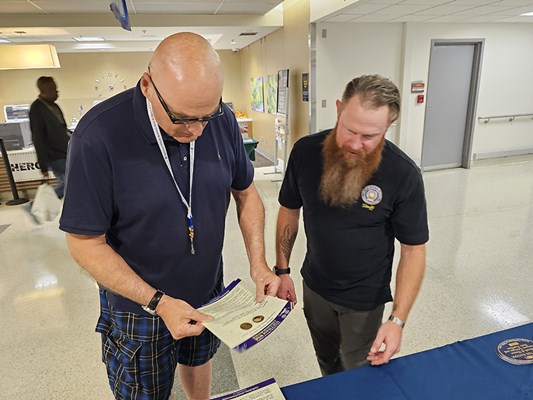 A vietnam veteran looks at the VWC information materials.