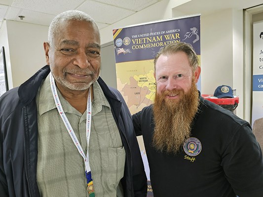 A Vietnam veteran receives a VVLP from a V