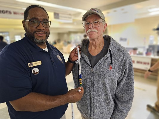 A Vietnam veteran receives a VVLP from a VWC staff member.