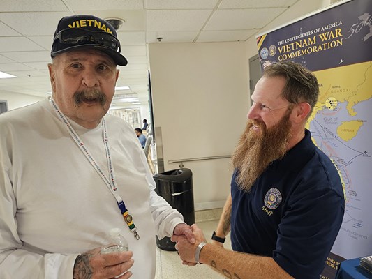 A Vietnam veteran receives a VVLP from a VWC staff member.