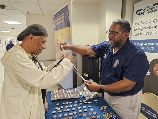 A Vietnam veteran receives a VVLP from a VWC staff member.