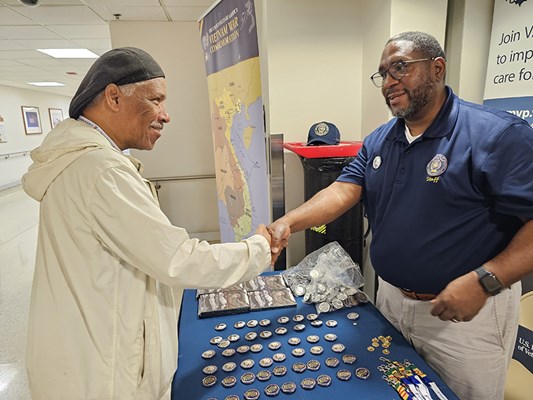 A Vietnam veteran receives a VVLP from a VWC staff member.