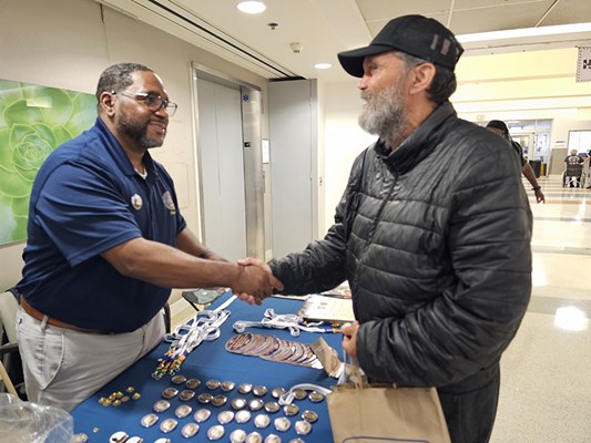 A Vietnam veteran is greeted by a VWC staff member.