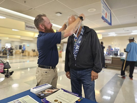 A Vietnam veteran receives a VVLP from a VWC staff member.
