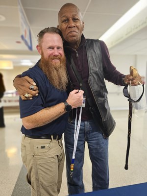A Vietnam veteran poses with a VWC staff member after receiving a VVLP.0240523_124424_REV