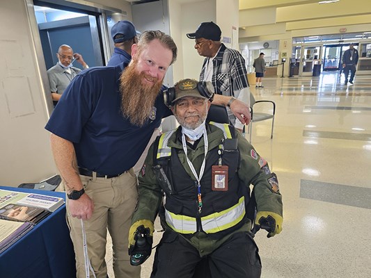A Vietnam veteran receives a VVLP from a VWC staff member.