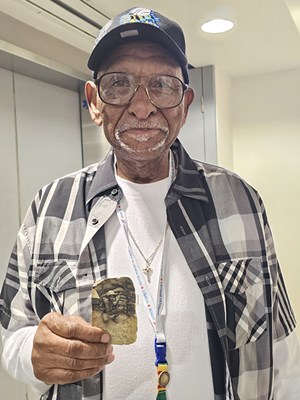 After being presented a VVLP, this veteran holds an old photo of himself during the Vietnam War.