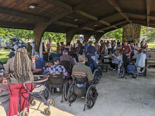 Veterans share an outdoor meal during a cookout.