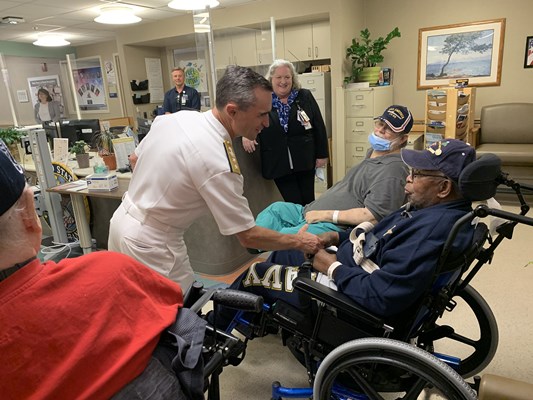 Rear Adm. Douglas G. Perry reaches out to a veteran.