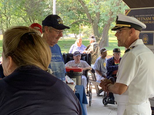 Commander Brian T. Wierzbicki, Chief, Public Engagement of the VWC, greets veterans. 