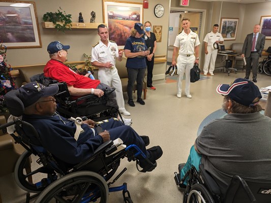 Rear Adm. Douglas G. Perry speaks with veterans and staff.