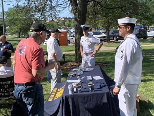 Navy personnel speak with veterans.