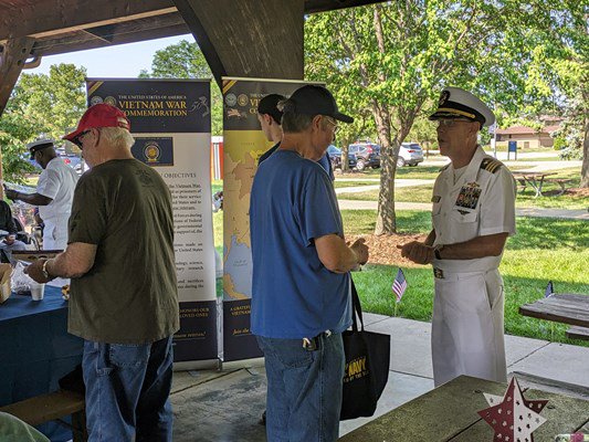 Commander Brian T. Wierzbicki, Chief, Public Engagement of the VWC, speaks to a veteran.