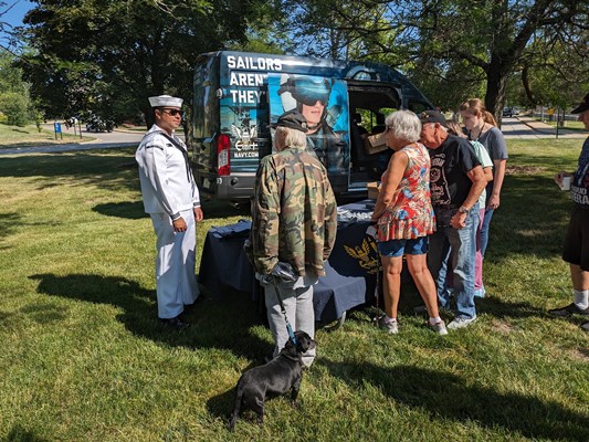 Navy personnel speak with veterans.