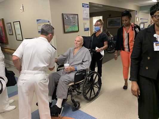 Rear Adm. Douglas G. Perry greets a veteran.