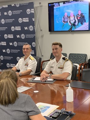 Rear Adm. Douglas G. Perry meets with administrators.