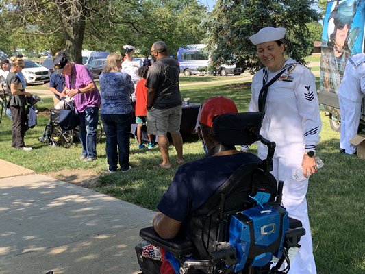 Navy personnel greet veterans.
