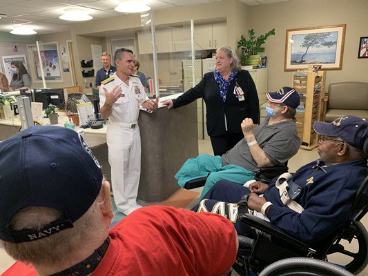 Rear Adm. Douglas G. Perry speaks to veterans and hospital administrators.