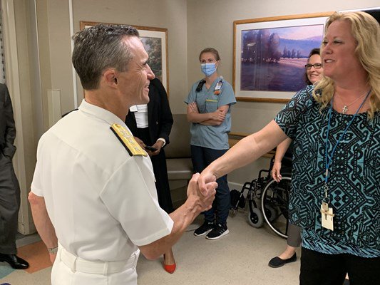 Rear Adm. Douglas G. Perry greets a VA administrator.