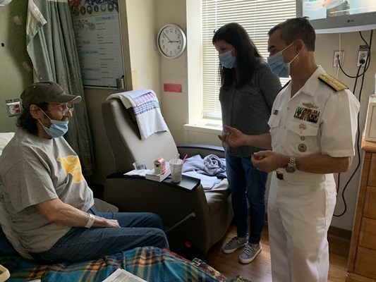 Rear Adm. Douglas G. Perry speaks with the veteran.