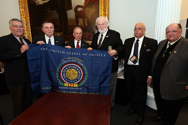 Mayor Michael Bloomberg accepts the Vietnam War Commemoration flag at New York City Hall.  Bloomberg
