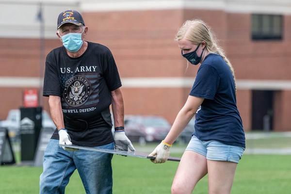 Volunteers help assemble The Wall That Heals