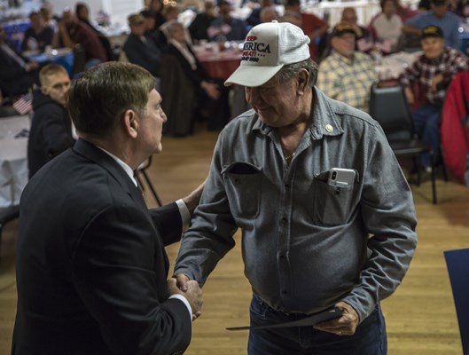 U.S.A. Vietnam War 50th Commemoration Assistant Director Larry Brom honors a Vietnam veteran.