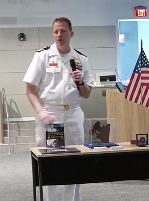 CDR Thomas Digan helps welcome people to the day's events.