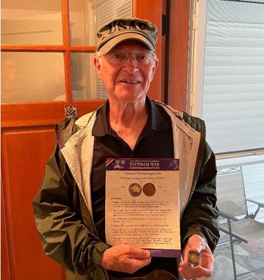 Vietnam veteran Chuck Chapleau displays his Vietnam veteran lapel pin and fact sheet. He served in t